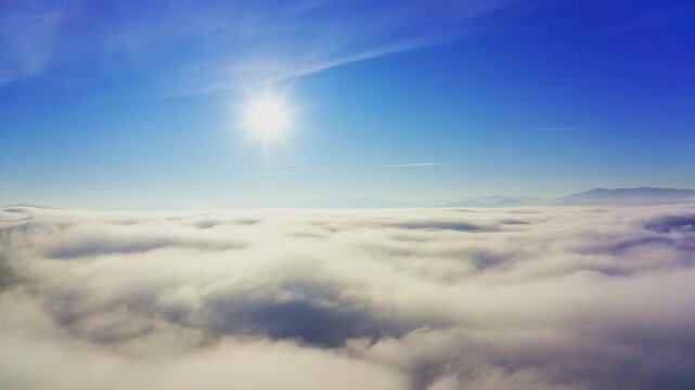 Wonderful view of extraordinary cloudy valley and bright orange sunset