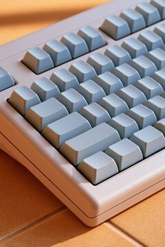 Retro Computer Keyboard With Blue Keycaps On A Tile Desk Surface Close Up