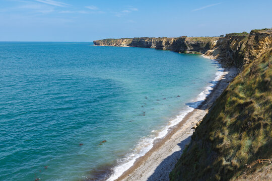 Grassy cliffs overlook the English Channel in the Normandy region of France.