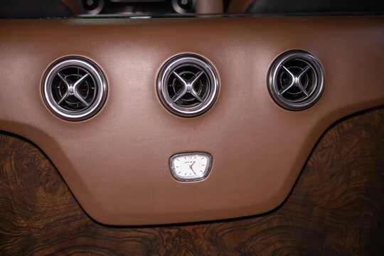 Luxurious brown leather interior of a Mercedes V-Class. High-end business cabin with premium upholstery, wood trim elements, and ambient lighting. Ultimate comfort and sophistication for VIP passenger