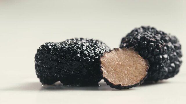 Truffle mushroom, Fresh Black Truffles on Rustic Wooden Board, Gourmet Delicacy, Luxury Culinary Ingredient, Close Up Macro Video for Restaurant and Cafe Menu