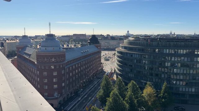 Curved Glass Office Building Seen From a Nearby Rooftop