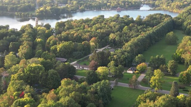 Aerial over Berrien Springs, in Berrien County, within the Oronoko Charter Township, Michigan, United States. Approaching Lake Chapin, a dammed lake along the St. Joseph's River. 2023.