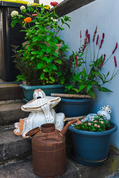 Colorful Potted Flowers and Whimsical Garden Ornaments on Stone Steps