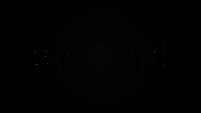White particles drift across a black background in a slow subtle animation
