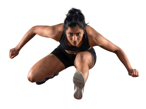 Athletic indian woman jumping over obstacle in sports clothing