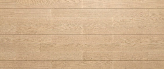 Oak wood plank flooring texture with natural light grain and staggered seams forming a warm modern...