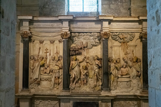   carved altar image (retable) with three baptism scenes in the Basilica of St. Remigius in Reims, France