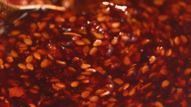 Chinese Crispy Chili Oil in Glass Jar, Homemade Chili Crisp with Garlic, Shallots and Sesame Seeds, Authentic Spicy Asian Condiment, Close Up Macro Video for Cafe and Restaurant Menu