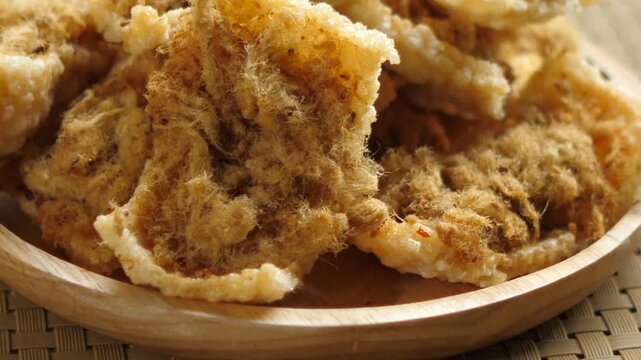Thai crunchy rice biscuits with seasoned meat floss on wood plate