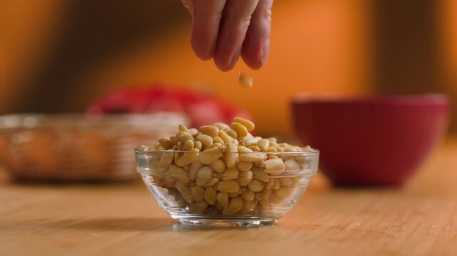 Pine Nuts Eaten by a Man, Person Cracking and Enjoying Fresh Cedar Pine Nuts as a Healthy Organic Snack