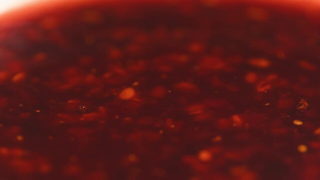 Chinese Crispy Chili Oil in Glass Jar, Homemade Chili Crisp with Garlic, Shallots and Sesame Seeds, Authentic Spicy Asian Condiment, Close Up Macro Video for Cafe and Restaurant Menu