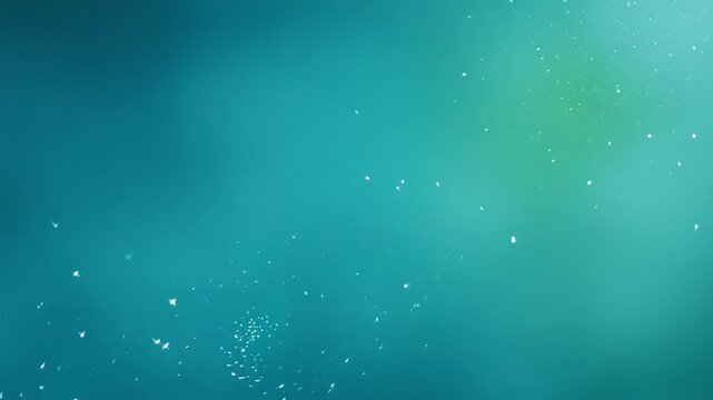 ?Mesmerizing falling snow particles in tranquil bluegreen background loop