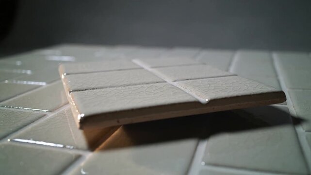 Moving camera closer revealing crackle glaze causing tile rocking and settling on mosaic table