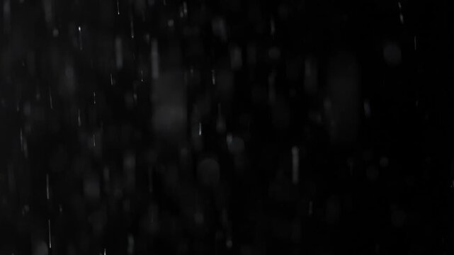 Wet snow and streams of water flow onto the black isolated background of the studio in dim lighting, an empty template for advertising objects.