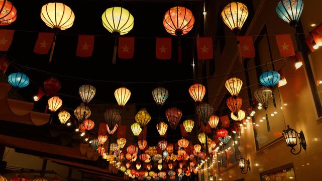 Da nang street at night showcasing a dazzling display of vibrant traditional vietnamese lanterns and national flags strung across, creating a warm, inviting, and festive ambiance in vietnam