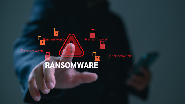 Hacker executes cyberattack ransomware malware holding files hostage, as ransom threat warning alerts cyberattack victim against malware extortion danger.