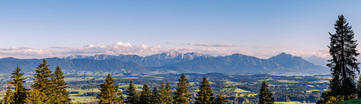 Panoramic view from Auerberg mountain over Bavarian Alpine foothills and majestic Ammergau Alps range at sunset, German country travel and mountain landscape concept