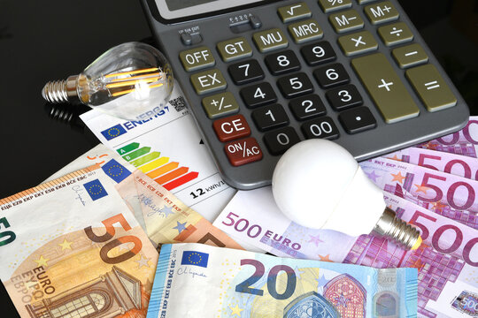 Energy Costs Concept with Calculator, Euro Banknotes and Light Bulbs