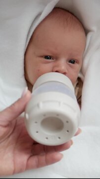 Vertical Video Of Mom Feeding Newborn Baby With Bottle. Vertical video