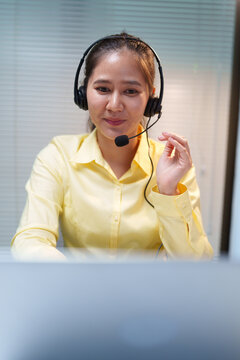 Female Call Center Assistant Wearing Headset at Work