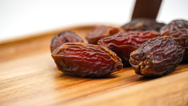 Close-Up of Sweet Premium Dried Dates on an Elegant Wooden Tray