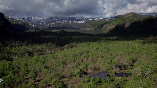 Aerial view of forested mountains and rural valley landscape