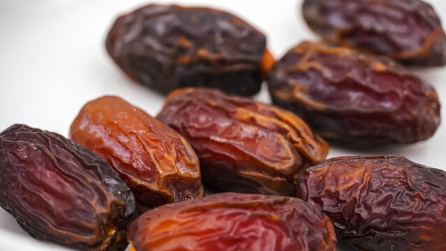 Close-Up of Sweet Premium Dried Dates on an Elegant Wooden Tray