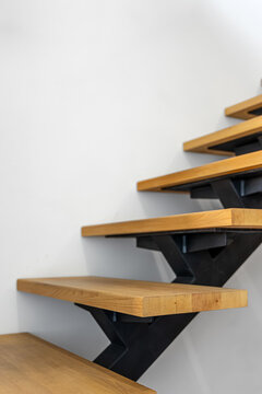 Wood and black metal staircase detail. Vertical interior frame with copy space.