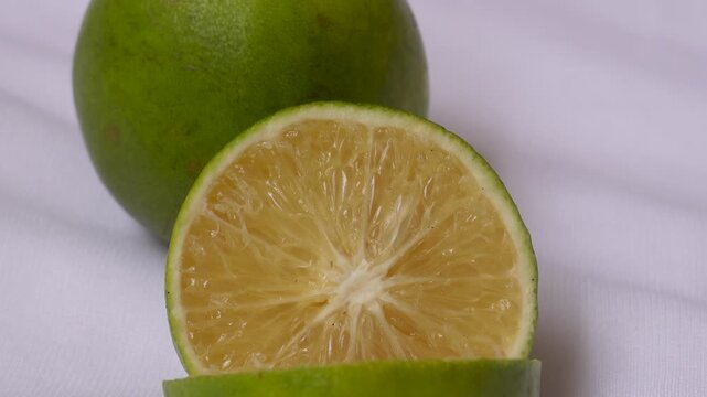Organic Indian Citrus fruit sweet limetta or mosambi with its sliced part on white background. It is a cross between the citron and a bitter orange. Scientific name Citrus limetta