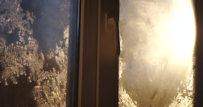 Close up of frost patterns on window glass, capturing the cold essence of winter. The process of frost patterns forming, time lapse video.