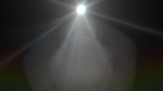 White Sunburst Lens Flare with Polygon Bokeh on Dark Background
