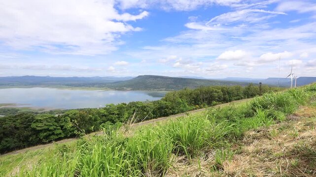 A scenic video view from the high-altitude wind turbine viewpoint at Khao Yai Thiang, Korat, Thailand, featuring beautiful scenery that overlooks the Lam Takhong Dam and wind energy infrastructure.