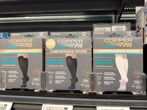 Frisco, Texas, USA - August 31th, 2026: Copper Fit energy compression socks product packages sitting in row on Walmart pharmacy shelf display