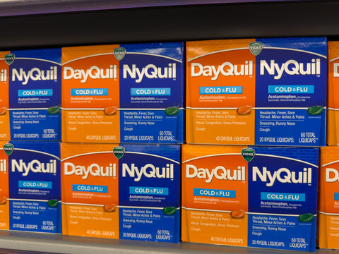 Frisco, Texas, USA - August 31th, 2026: Vicks NyQuil and DayQuil boxes sitting in organized rows on grey rack in Walmart pharmacy shelf
