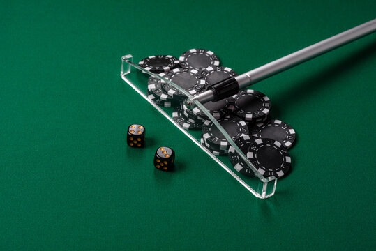 Dice and chips on a green felt gaming table, a poker game in a casino. Casino dice
