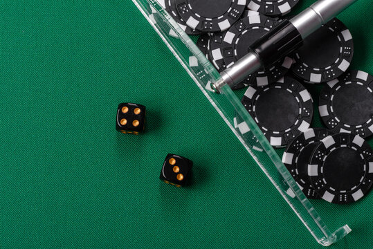 Dice and chips on a green felt gaming table, a poker game in a casino. Casino dice