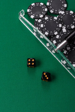 Dice and chips on a green felt gaming table, a poker game in a casino. Casino dice