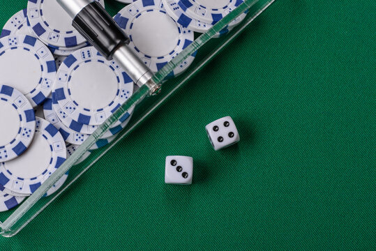 Dice and chips on a green felt gaming table, a poker game in a casino. Casino dice