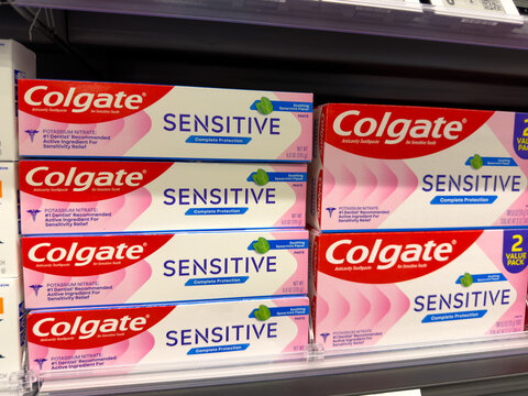 Frisco, Texas, USA - August 31th, 2026: Colgate Sensitive toothpaste red and white boxes stacked in order on Walmart pharmacy shelf