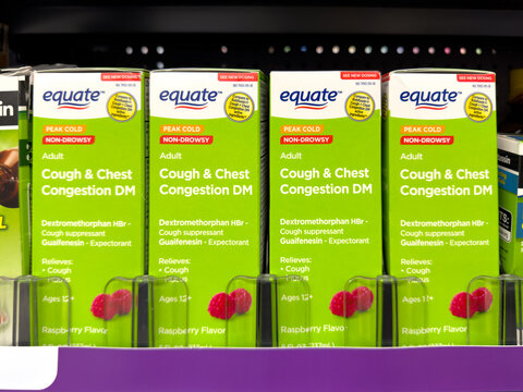Frisco, Texas, USA - August 31th, 2026: Equate adult peak cold non-drowsy cough and chest congestion DM raspberry medicine boxes in Walmart pharmacy display