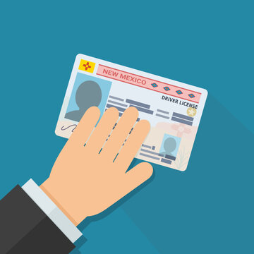 Hand holding a New Mexico Real ID driver license, symbolizing personal authentication, citizenship compliance, and official credential verification.