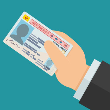 Hand presenting an official New Mexico Real ID driver license card, symbolizing legal identity verification, security check, personal authorization, and citizenship compliance.