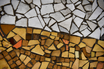 Abstract ceramic mosaic tile background in white, yellow, and brown tones
