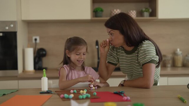 Mother and daughter crafting together at home