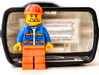 Fototapeta premium Russia, St. Petersburg, August 8, 2020. Lego man stands next to the headlight