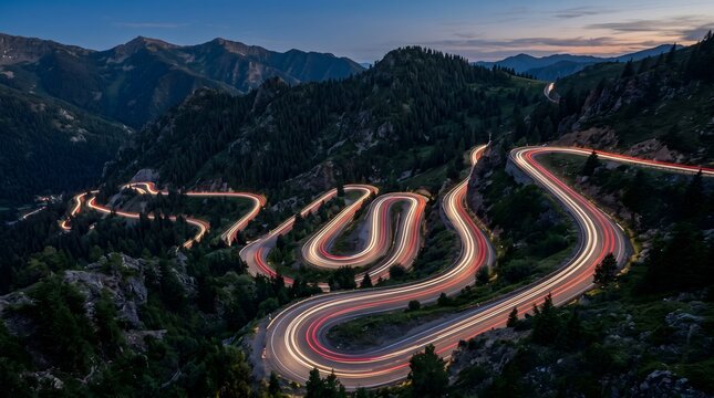 Winding mountain road with car light trails at twilight. Long exposure of alpine pass and transport.