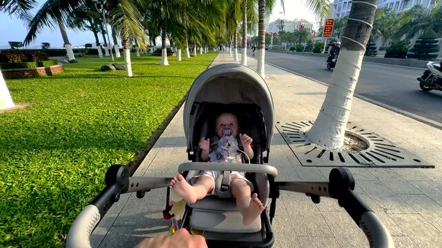 A small child is out for a walk in a stroller 
