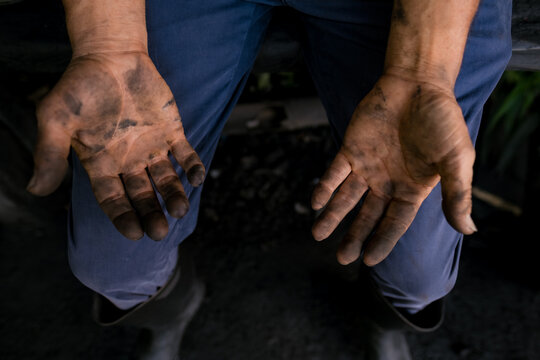 Worker with dirty hands doing hard labor