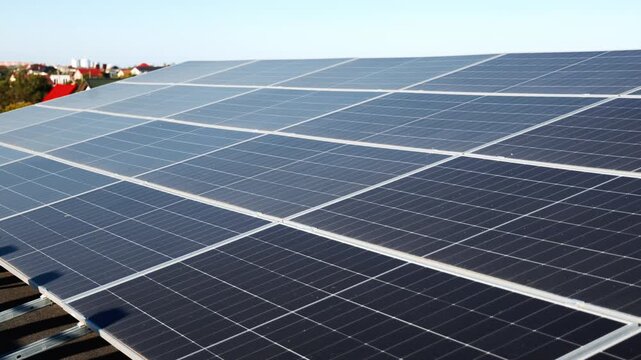 Wide array of rooftop solar panels overlooking a residential area. Renewable energy and urban clean power infrastructure concept.